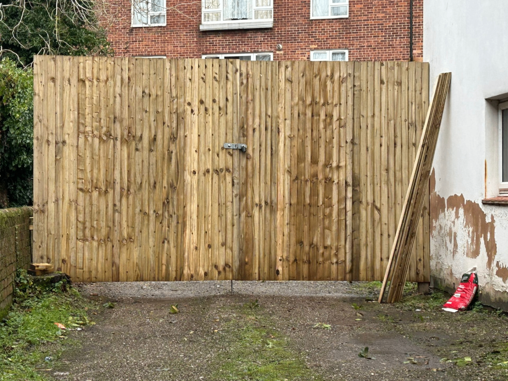 Tall pressure-treated timber gate and matching fence panel built by AJW Carpentry in East Devon